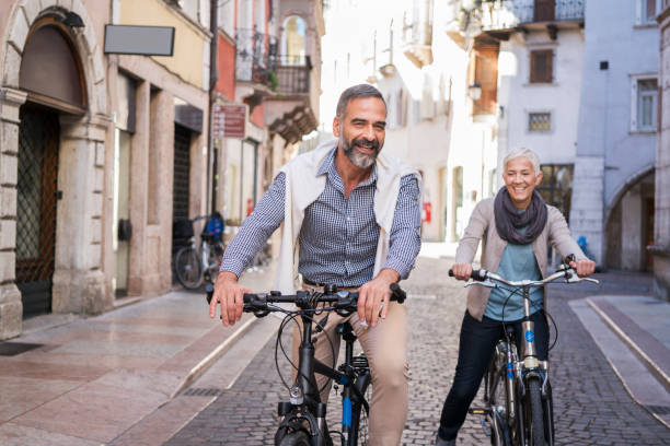 Couple biking through an Italian town